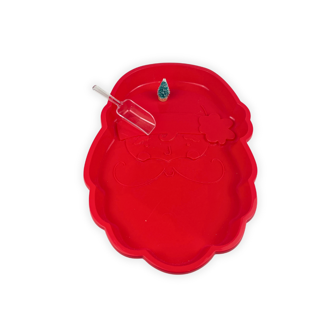 Toddler sensory play setup showing festive coloured rice and scooping activity in Santa tray