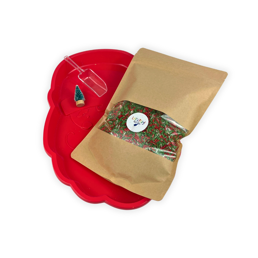 Santa-shaped sensory tray filled with festive red and green coloured rice for toddler sensory play